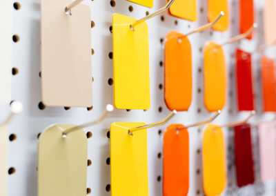 Warm tone paint swatches on a peg board.