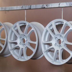 wheel rims hanging up that have been powder coated gray